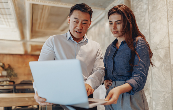colleagues collaborating on laptop project